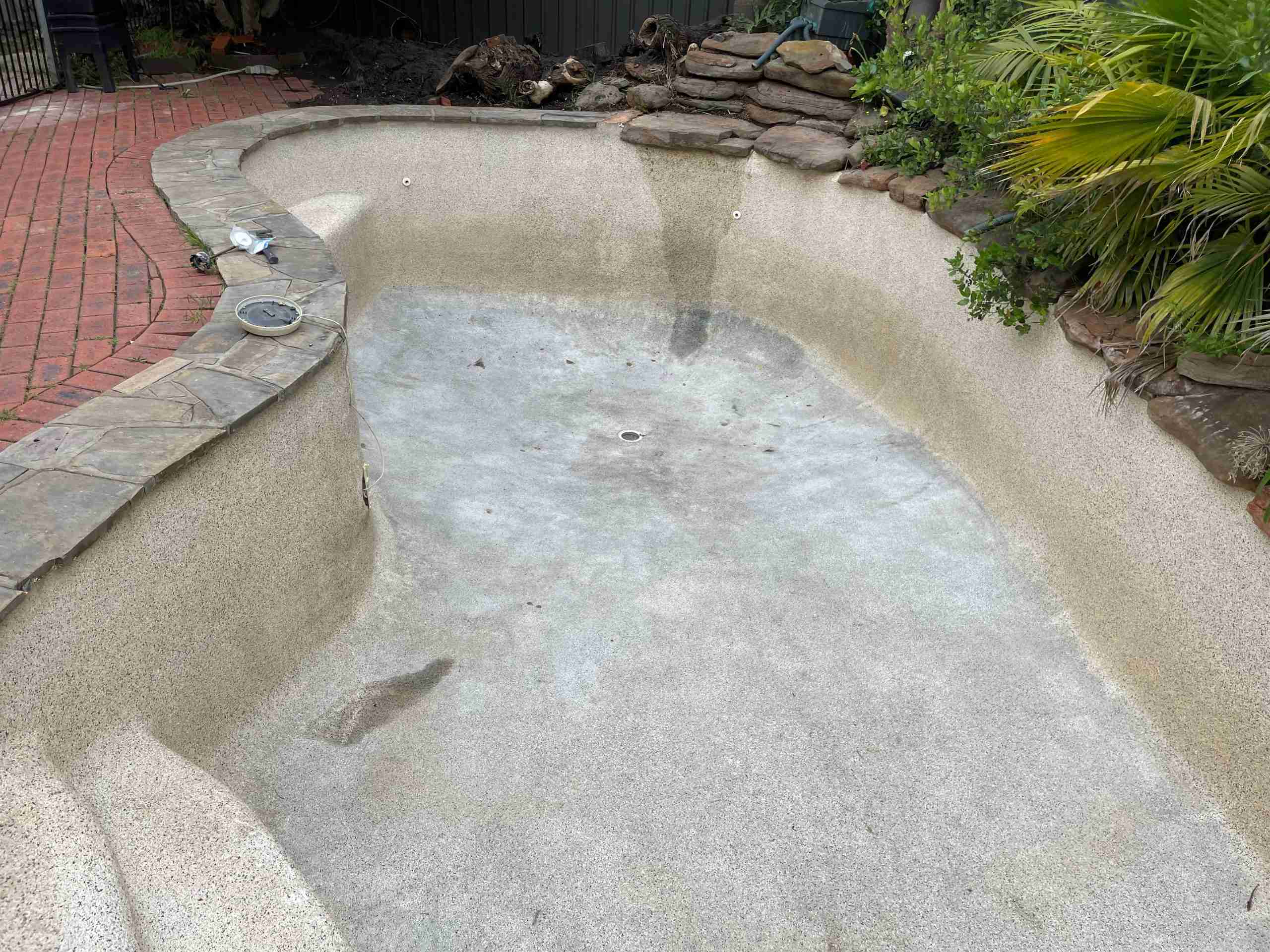 A concrete pool after a residential pressure clean. There's no more moss or sludge.