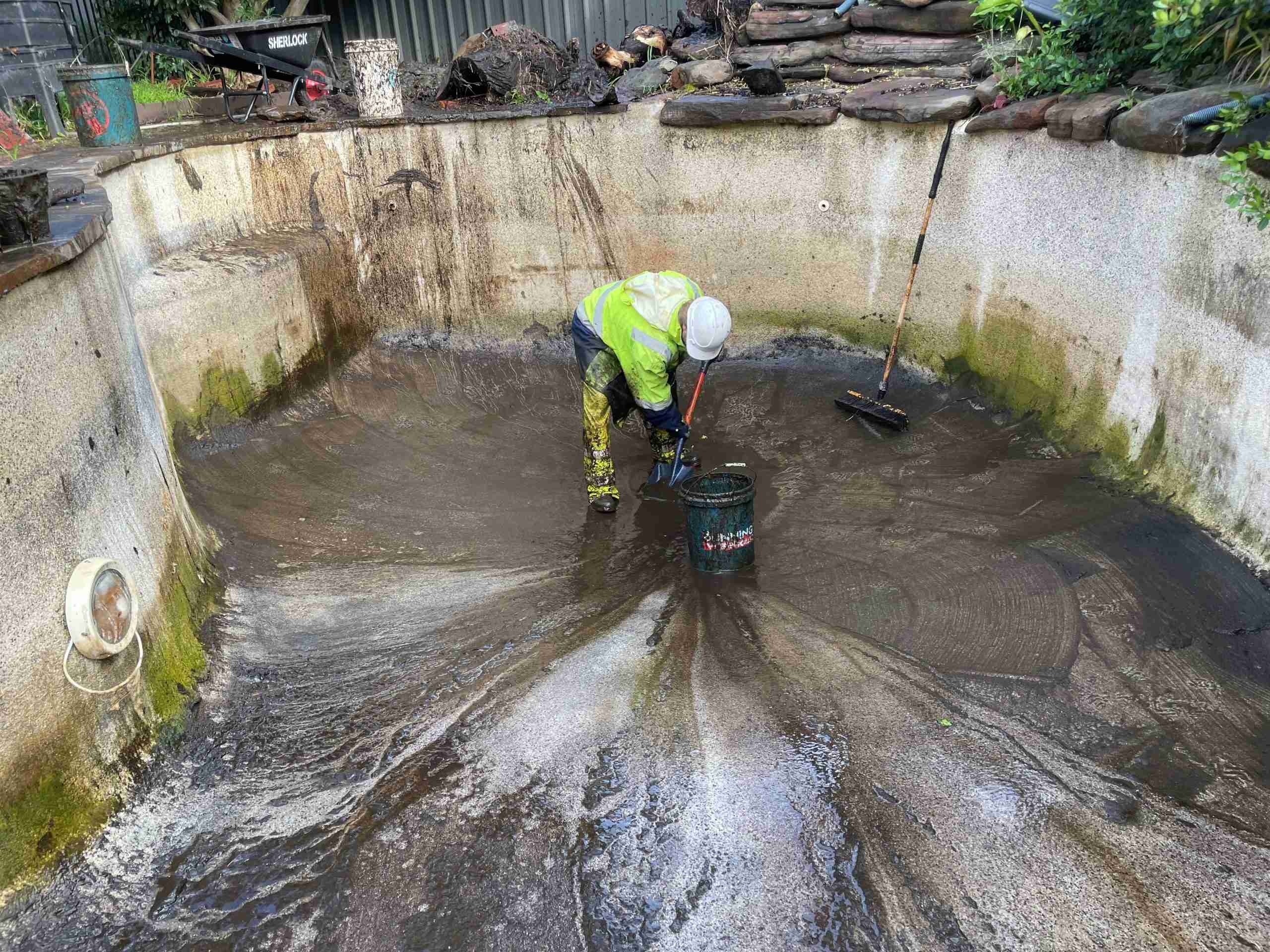 Residential pressure cleaning a pool that was once a fish pond. 