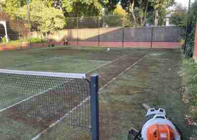 Sports court surface cleaning across Adelaide includes synthetic grass tennis courts. This tennis court is being cleaned to remove dirt and debris.