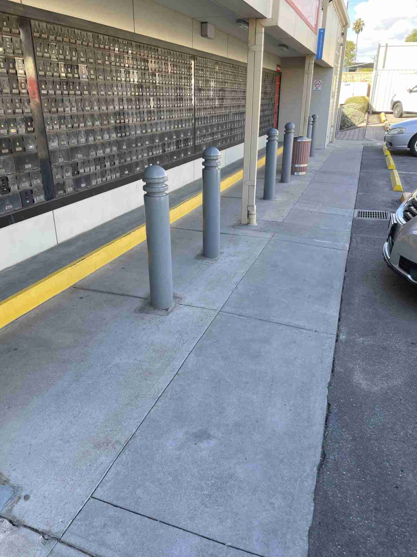 Southgate-Commercial-concrete-clean-Adelaide A wall of Australia Post post office boxes and a clean walkway after a high-pressure clean