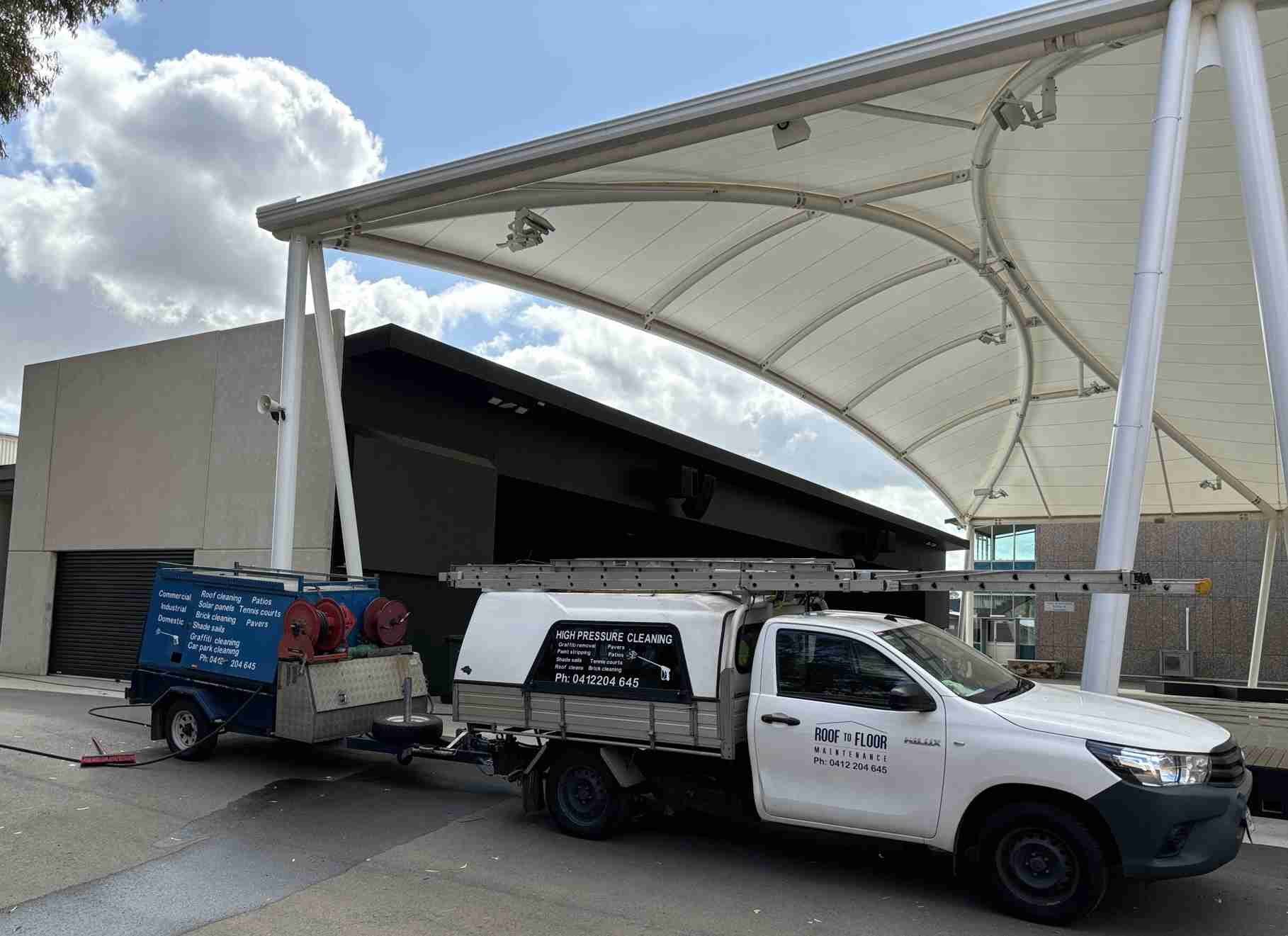 Roof to Floor Maintenance ute parked in front of a large shade sail at a commercial pressure cleaning job